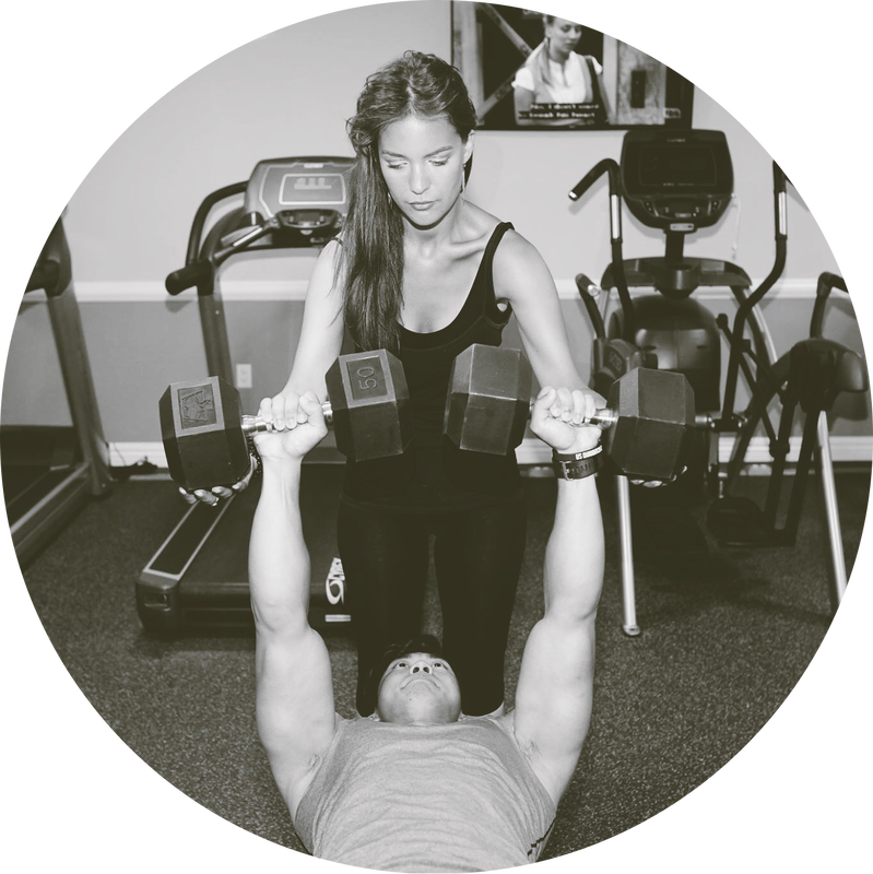 Personal trainer is training member to lift weights